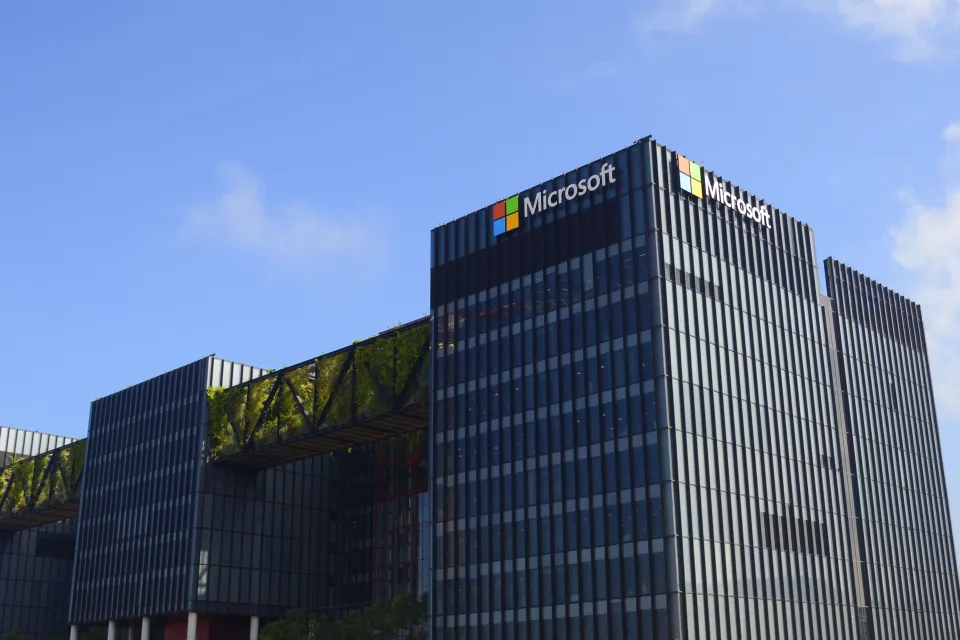 Exterior view of a Microsoft data center. Black multistory industrial building with Microsoft logo.